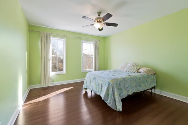 bedroom with ceiling fan and dark hardwood / wood-style floors