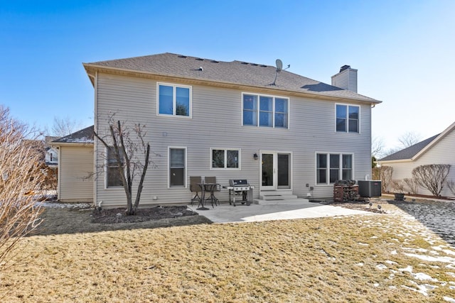 rear view of property featuring a patio, a yard, and cooling unit