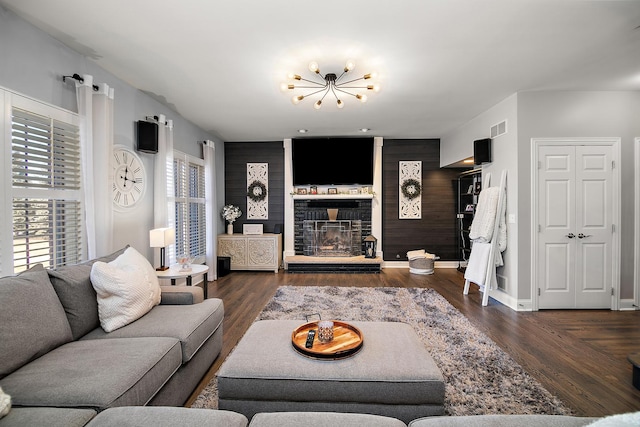 living room with dark hardwood / wood-style flooring and a chandelier