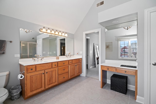 bathroom featuring lofted ceiling, a shower with door, tile patterned flooring, vanity, and toilet