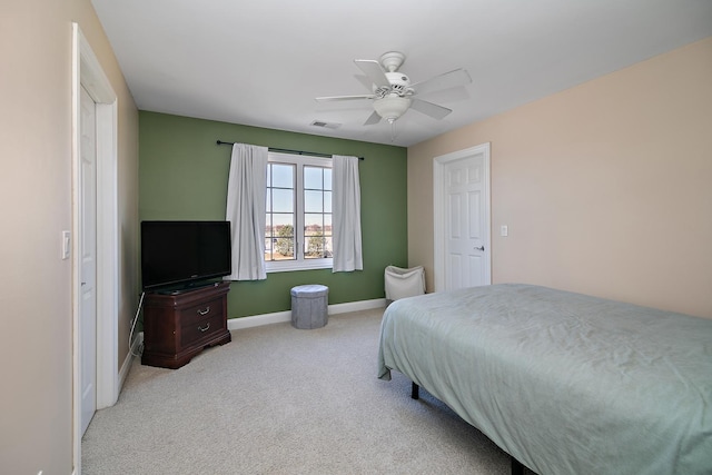 bedroom featuring ceiling fan and light carpet