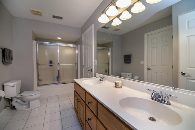 full bathroom featuring tile patterned flooring, vanity, shower / bath combination with glass door, and toilet