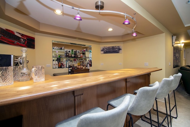 bar with a raised ceiling and butcher block counters