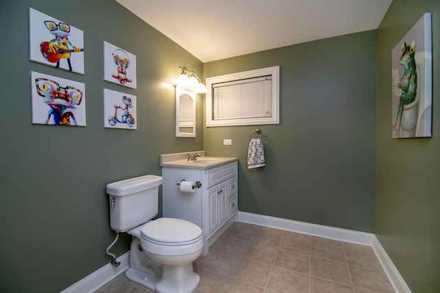 bathroom featuring vanity, tile patterned flooring, and toilet