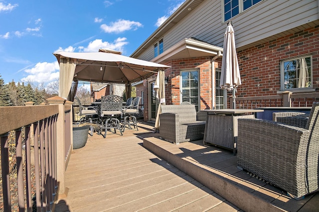 wooden terrace with an outdoor living space and a gazebo