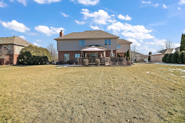 rear view of house with a gazebo and a lawn