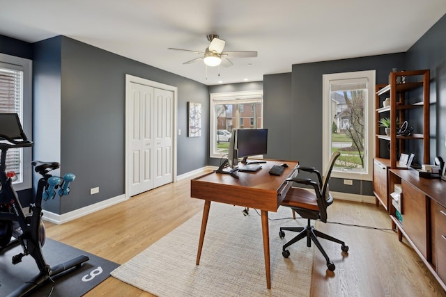 office area featuring plenty of natural light, ceiling fan, and light hardwood / wood-style flooring