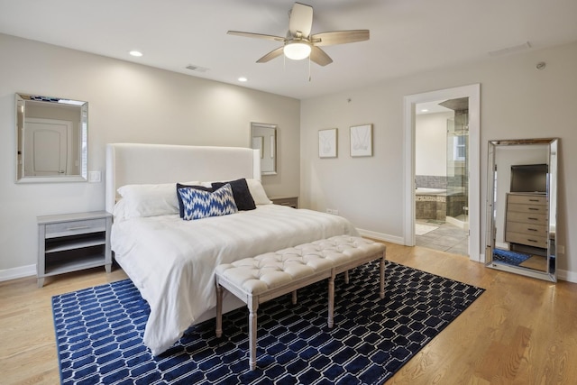 bedroom with hardwood / wood-style flooring, ensuite bath, and ceiling fan