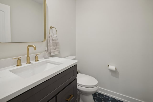 bathroom featuring vanity, toilet, and tile patterned flooring