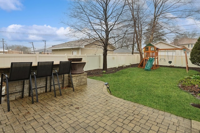 view of patio with an outdoor bar and a playground