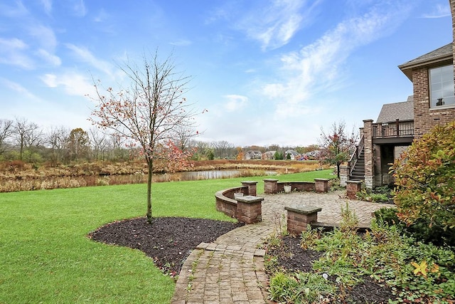 view of yard with a deck with water view