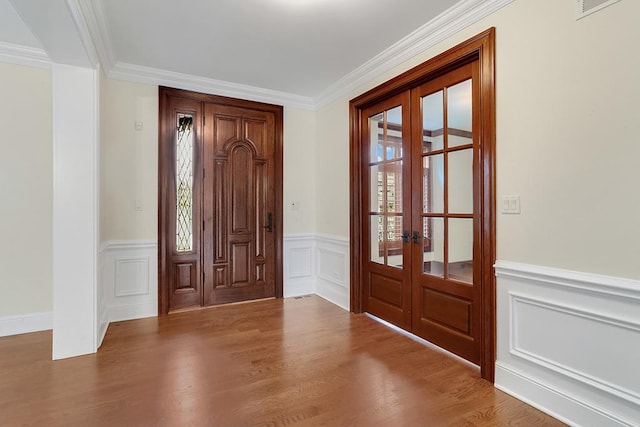 foyer featuring french doors, ornamental molding, and wood-type flooring