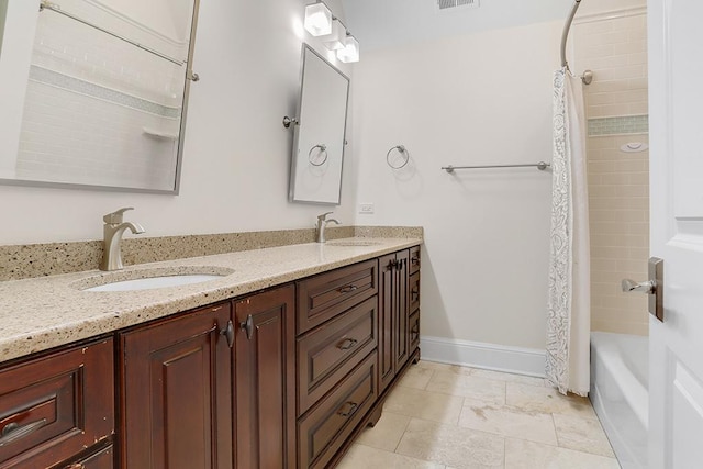 bathroom featuring vanity and shower / bath combination with curtain