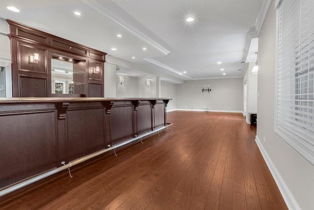 bar with ornamental molding and dark hardwood / wood-style floors