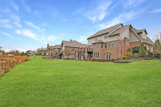 exterior space featuring a wooden deck and a lawn