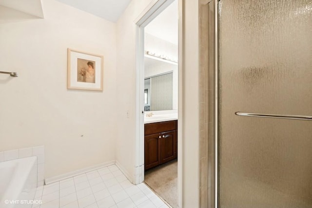 bathroom featuring vanity, shower with separate bathtub, and tile patterned flooring