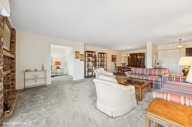 living room with an inviting chandelier, light colored carpet, and a brick fireplace