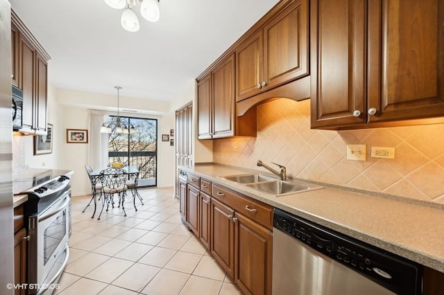 kitchen with sink, light tile patterned floors, appliances with stainless steel finishes, pendant lighting, and decorative backsplash