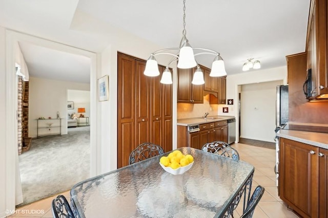 dining room featuring sink and light colored carpet