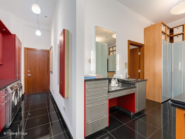 hall with stacked washer / dryer and a high ceiling