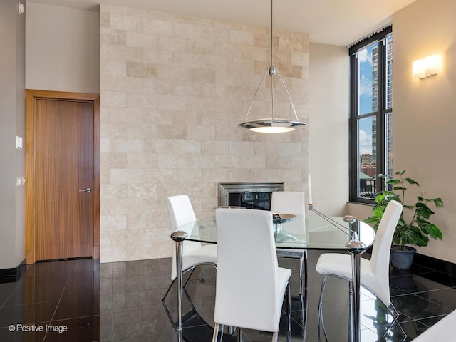 dining space featuring floor to ceiling windows and tile walls