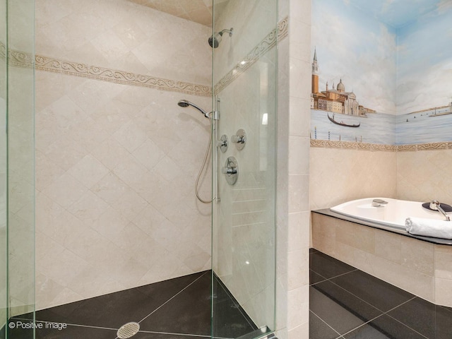 bathroom featuring tile walls and independent shower and bath