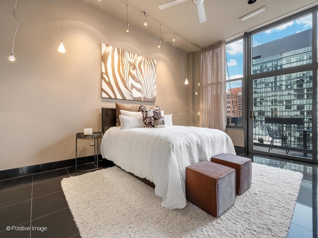 tiled bedroom with access to outside, floor to ceiling windows, and ceiling fan