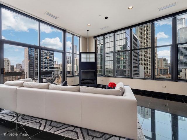 tiled living room with expansive windows and a healthy amount of sunlight