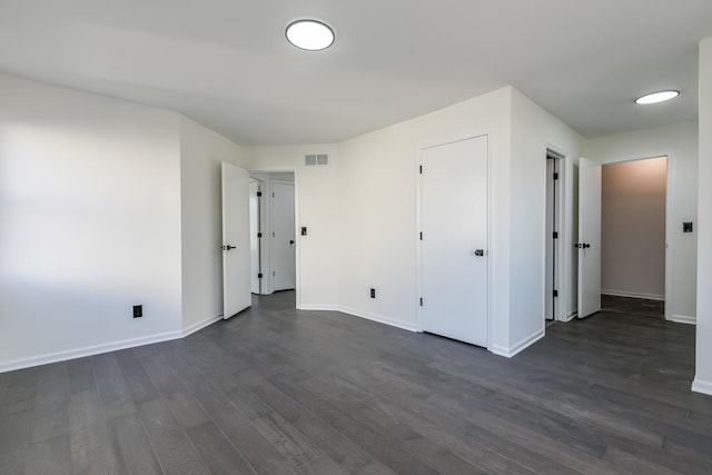 unfurnished bedroom featuring dark hardwood / wood-style floors