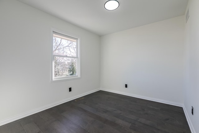 empty room featuring dark hardwood / wood-style flooring