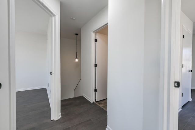 hallway with dark hardwood / wood-style flooring