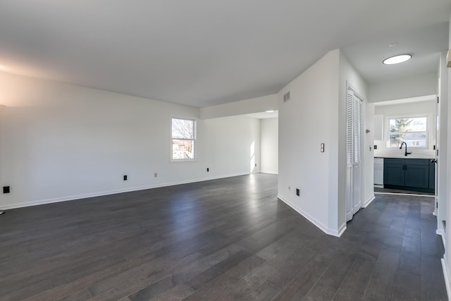 spare room with sink and dark hardwood / wood-style floors