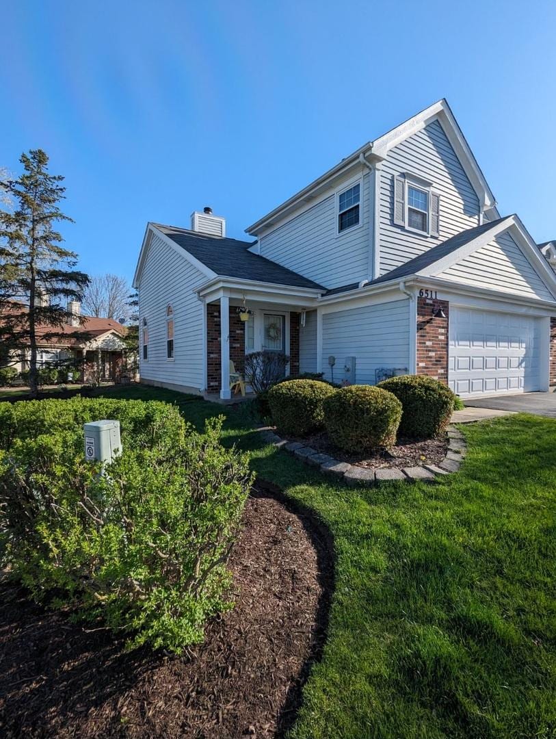 front of property with a garage, a front lawn, and central air condition unit