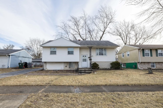 raised ranch featuring a front lawn