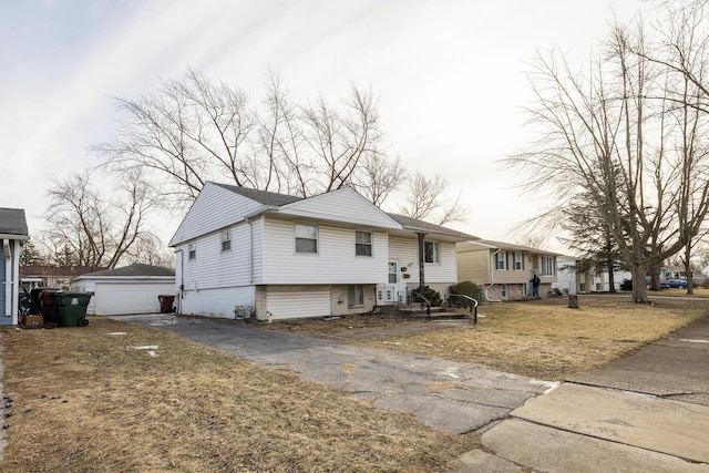 view of front of house featuring a garage and an outdoor structure