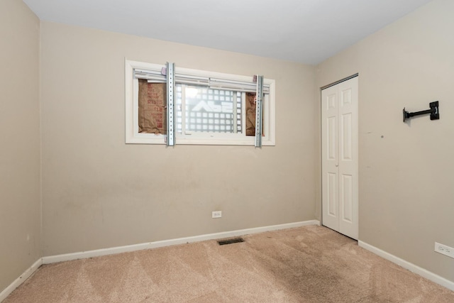 empty room with light colored carpet