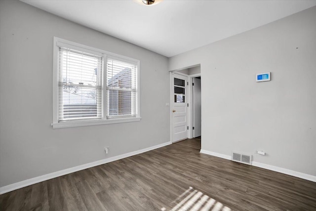 empty room featuring dark wood-type flooring