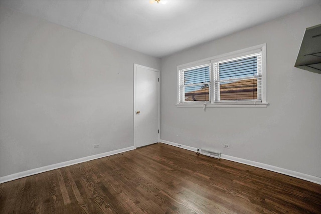 unfurnished room featuring dark wood-type flooring