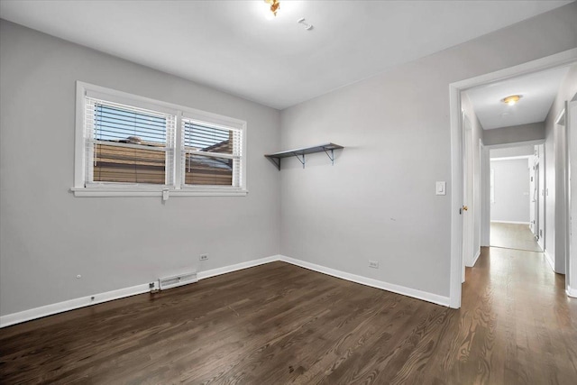 unfurnished room featuring dark hardwood / wood-style flooring