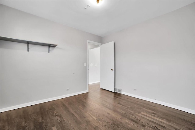 spare room with dark hardwood / wood-style flooring