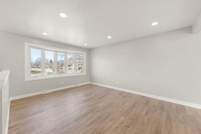 spare room featuring light hardwood / wood-style flooring