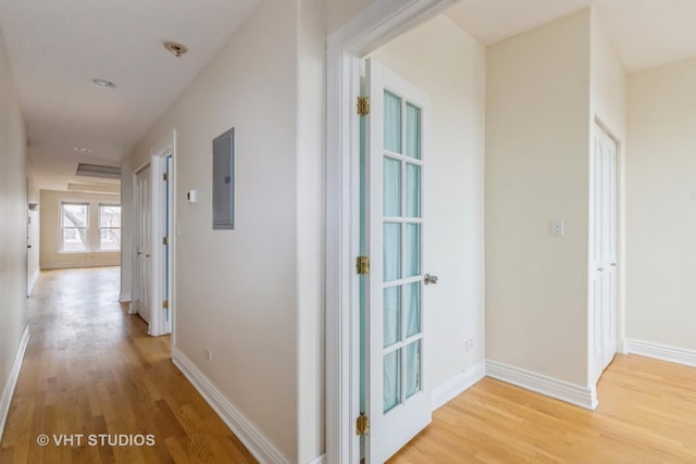 hall with electric panel and light hardwood / wood-style floors