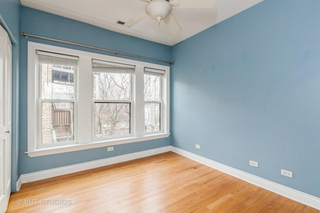 unfurnished room featuring hardwood / wood-style floors and a wealth of natural light