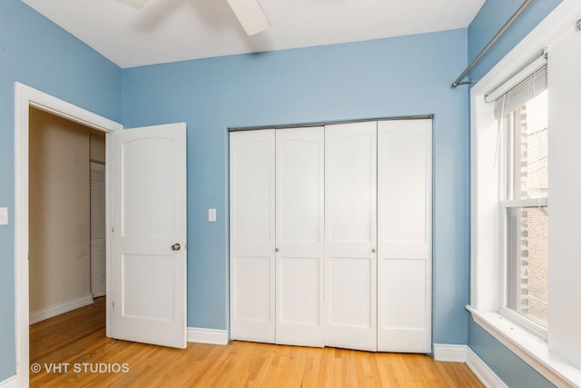 unfurnished bedroom with ceiling fan, a closet, and light hardwood / wood-style flooring