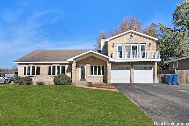 view of front of home with a garage and a front lawn