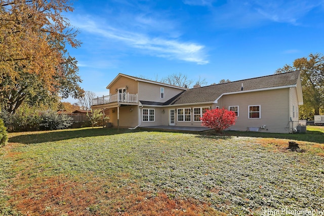 rear view of property with a yard and central AC