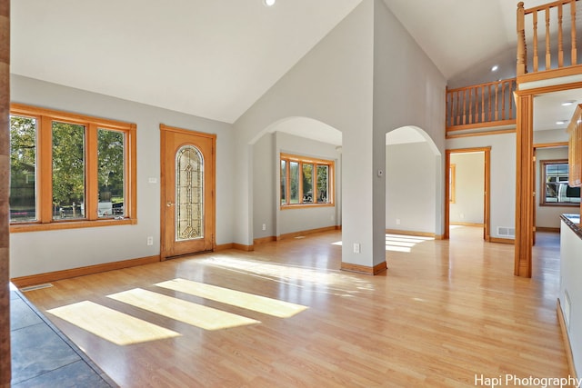 foyer featuring high vaulted ceiling and light wood-type flooring