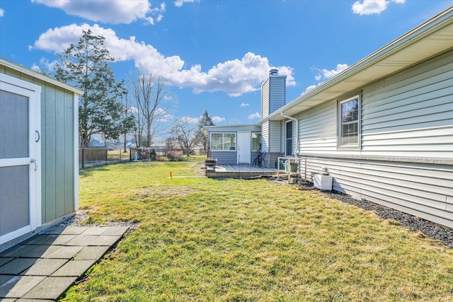 view of yard with a storage unit and a deck