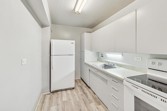 kitchen featuring sink, white appliances, light hardwood / wood-style floors, and white cabinets