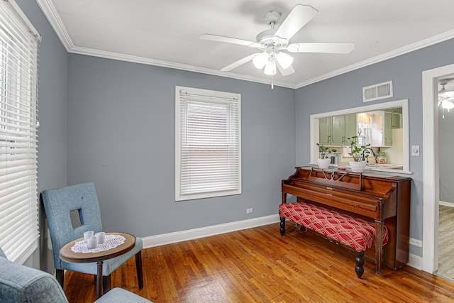 sitting room featuring crown molding, ceiling fan, and wood-type flooring